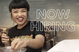 A barista at Philz Coffee preparing a beverage and the words "now hiring."